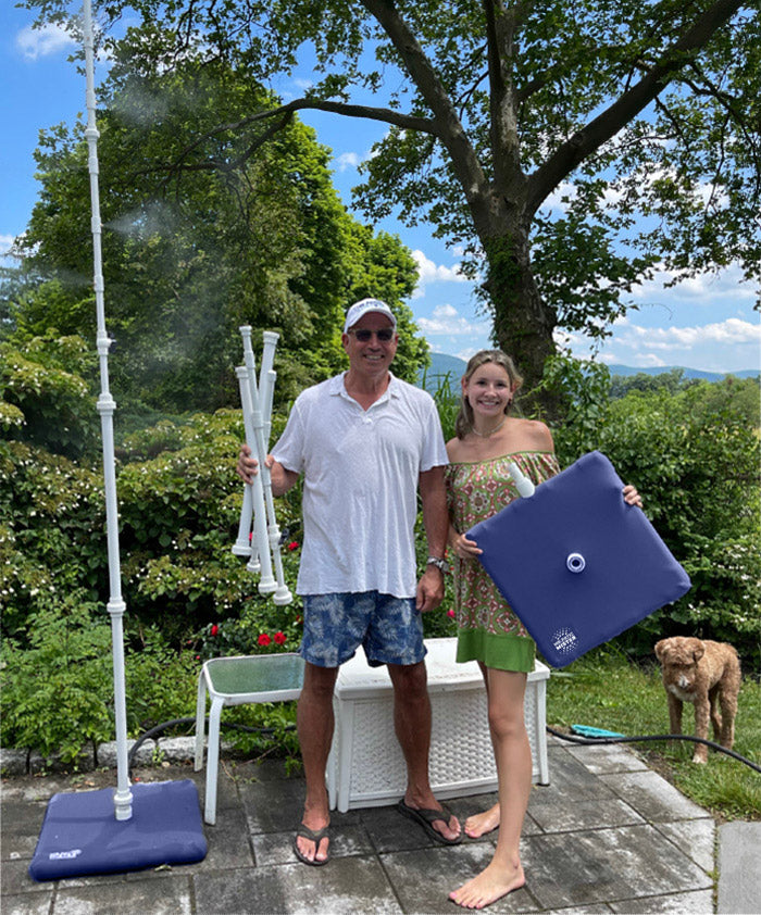 Jonathan and Olivia Burke on their patio beside the MR.PATIOMISTER as it mists