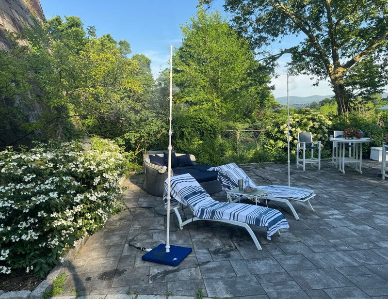 MR.PATIOMISTER on a serene garden patio with white lounge chairs and blooming flowers