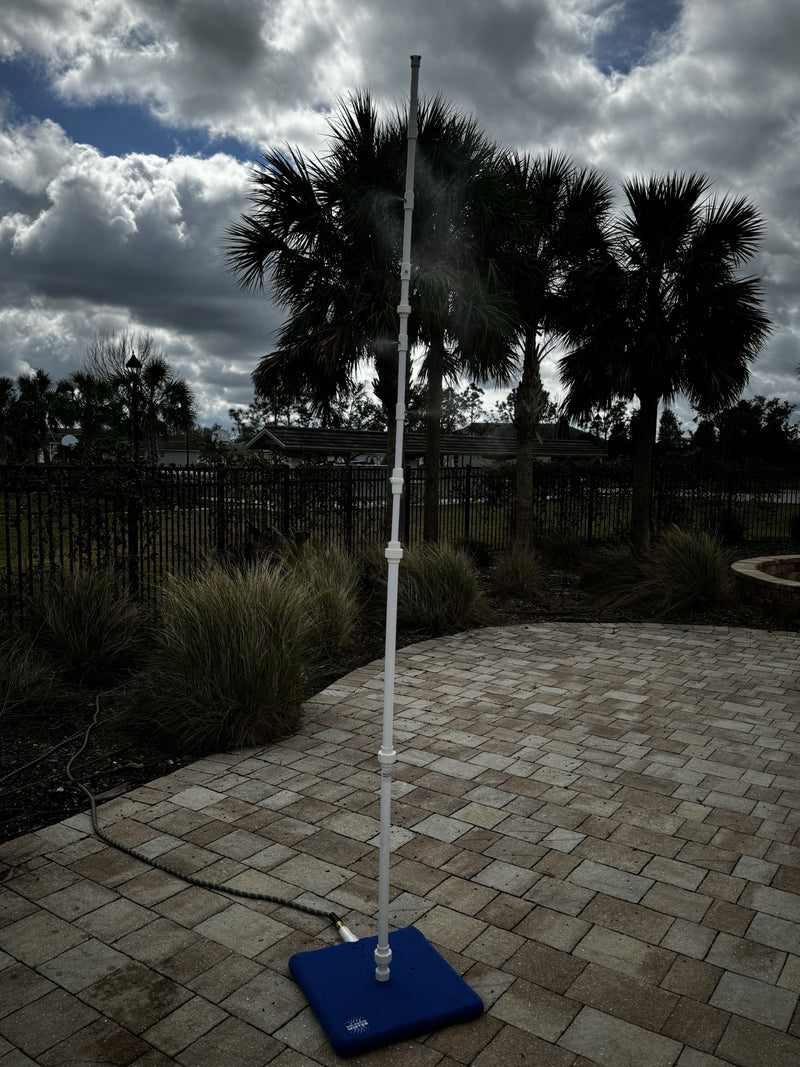 MR.PATIOMISTER standing on a paved patio with silhouetted palm trees against a dramatic sky
