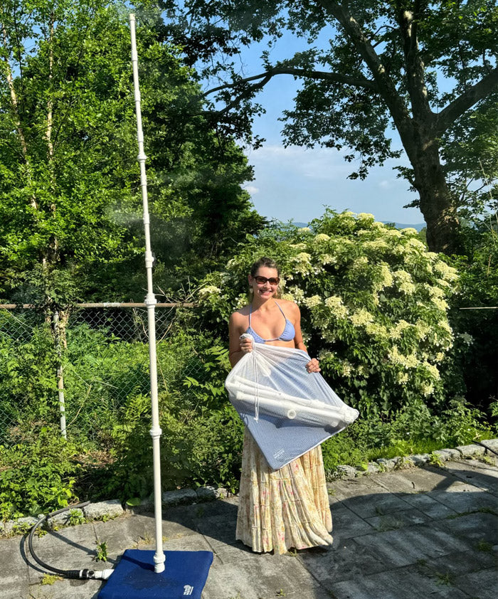 Olivia Burke in the backyard holding the MR.PATIOMISTER misting frame
